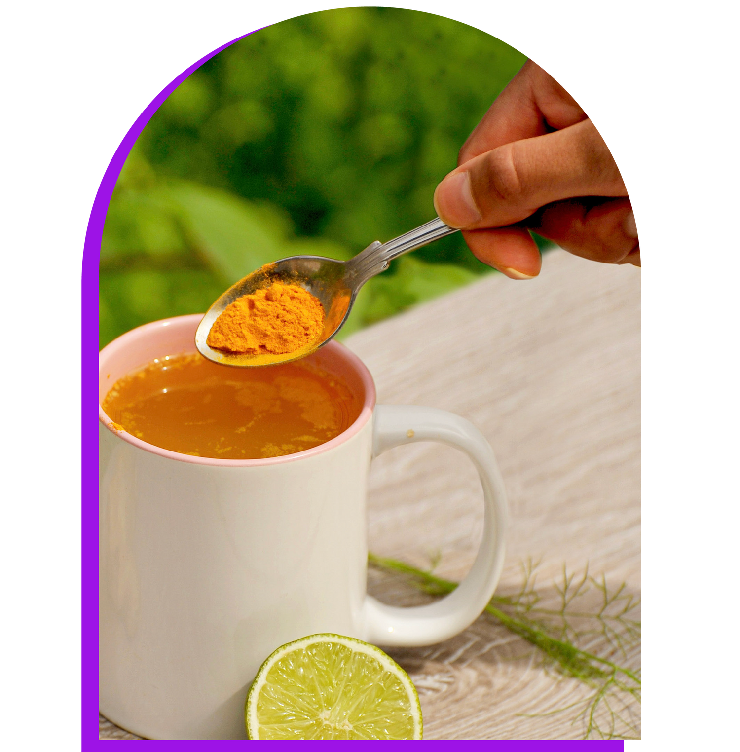 spoon of sustainably sourced turmeric powder spice over a mug of tea and slice of lime