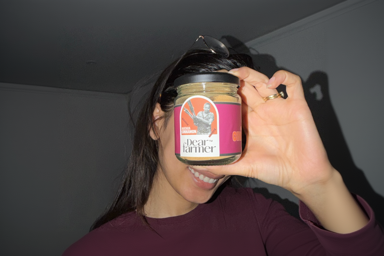 Person holding a jar of 'Dear Farmer' product in front of their face.